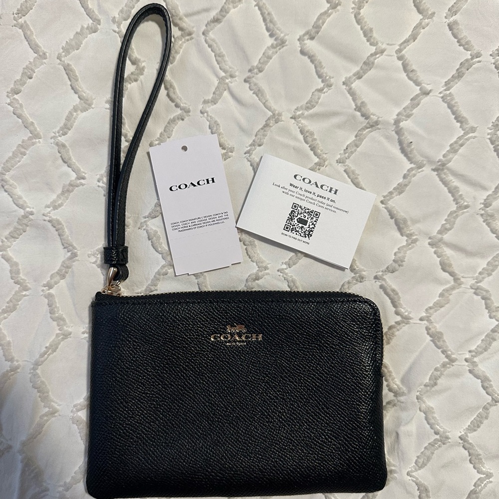 Black Coach wristlet purse. Never used. Still has tags.